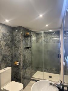a bathroom with a shower and a toilet and a sink at La 75 Stella Home Catania in Catania