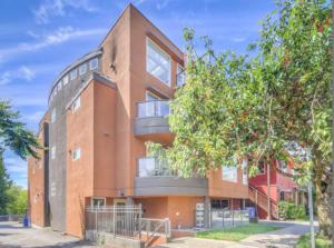 a brick building with balconies on the side of it at Boutique Beach Apartment in Vancouver