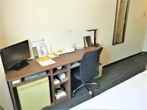 a room with a desk with a computer and a chair at Smile Hotel Mito - Vacation STAY 99841v in Mito +22 photos