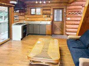 a living room with a couch and a table at Washiki Shiki no Sato Cottage - Vacation STAY 03146v in Wajiki