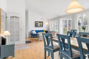 a dining room and living room with a table and chairs at SB109-Aabenraa-Golfsvinget-40 in Aabenraa