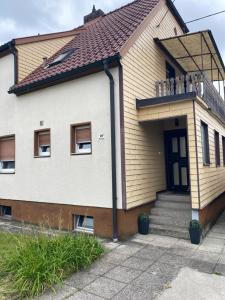 a white house with a brown roof at GünON Houses 19 in Linz