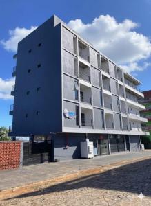 a largeartment building with a blue building at Risol in Encarnación