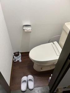 a bathroom with a toilet and a pair of shoes at Chambord Kyomachi - Vacation STAY 15547v in Kumamoto