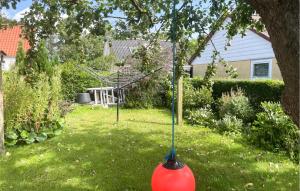 a swing in a yard with a tree at 2 Bedroom Gorgeous Home In Tranekær in Tranekær