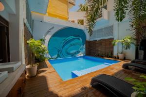 a swimming pool in the middle of a house at Hotel Bahia Chac Chi in Isla Mujeres