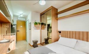 a bedroom with a white bed in a room at Studio aconchegante! in Salvador +32 photos