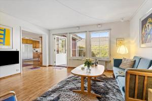 a living room with a couch and a table at TV1360-Bindslev-Munkebakken-5 in Bindslev