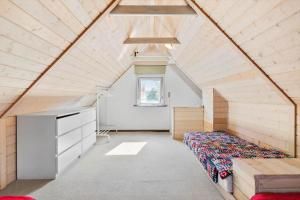 a bedroom with a bed and a dresser in a attic at TV1541-Hirtshals-Hojersgade-19-A in Hirtshals