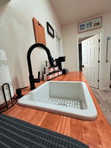 a sink in a kitchen with aaucet at Modern Studio with Exterior Independent Entrance in Orlando