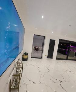 a large room with marble floors and windows at Peaceful home in Moorside