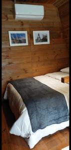 a bedroom with two beds and pictures on the wall at Chalé Valentina com Hidro - oktoberfest in Blumenau