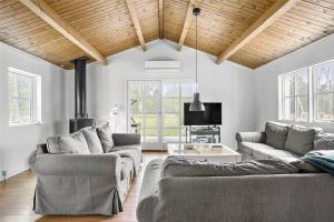 a living room with two couches and a fireplace at TV1321-Bindslev-Uglevej-8 in Bindslev