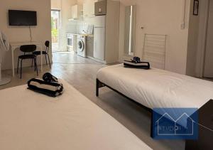 a living room with two beds and a kitchen at Studio 54 in Villerupt
