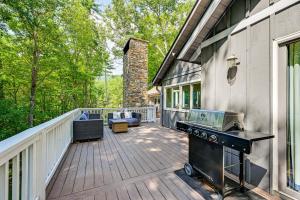 a large deck with a grill on the side of a house at Mountain Bearadise Home with Stunning Views in Sapphire