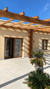 a house with a wooden pergola at La Dimora del Principe Luxury House in Mazara del Vallo