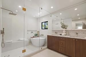 a bathroom with a tub and a sink and a shower at The Dona Modern in Los Angeles +31 photos