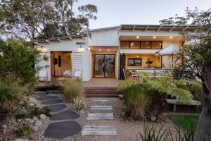a home with a pathway leading to the front door at Oyster Catcher Huskisson in Huskisson