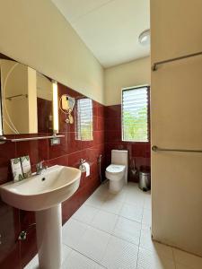 a bathroom with a sink and a toilet at LRS Apartment in Basdiot +15 photos