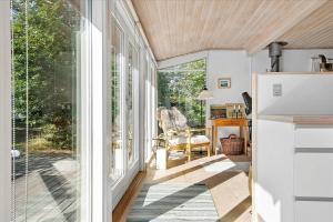 a screened in porch with a sliding glass door at TV1308-Albaek-Zefyrvej-4 in Ålbæk