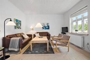 a living room with a couch and a table at TV1405-Skagen-Skomagergangen-5 in Skagen