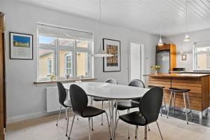a kitchen and dining room with a table and chairs at TV1405-Skagen-Skomagergangen-5 in Skagen