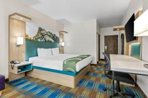 a hotel room with a bed and a desk at Quality Inn Brookings-University in Brookings +28 photos