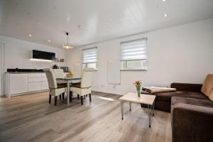a living room with a couch and a table at Ferienhaus-Kira in Rechlin