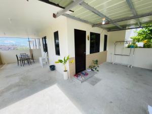 a patio of a house with a table and chairs at Marys Air B&B in Casa Mira South in San Fernando +4 photos