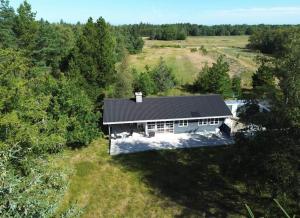 an overhead view of a house in the woods at TV1638-Albaek-Orionvej-11 in Ålbæk +18 photos