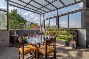 a patio with a glass table and two chairs at Terraza & Loft San Ángel in Mexico City