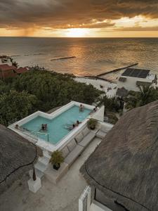 an overhead view of a swimming pool and the ocean at Casa Astral Hotel Boutique and Apartments in Holbox Island