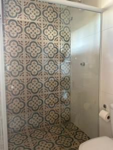 a bathroom with a glass shower with a toilet at Casa Rio de Contas - Renovada e Ampliada in Rio de Contas +17 photos