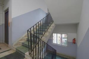 a staircase in a house with a window at Collection O Bricks Inn Hazra Road Near Birla Mandir in Ballygunge