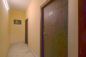 a wooden door in a room with a hallway at Collection O Bricks Inn Hazra Road Near Birla Mandir in Ballygunge +31 photos