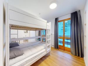 a bedroom with two bunk beds and a window at Chalet with Stunning Mountain Views in Agettes