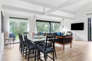 a dining room and living room with a table and chairs at TV1632-Bindslev-Margueritevej-7 in Bindslev