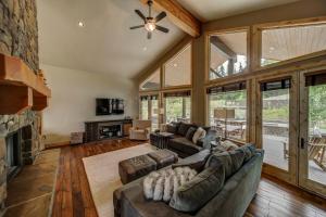 a living room with a couch and a fireplace at Bear Discovery Custom Tamarack Estate Home by Casago McCall - Donerightmanagement in Donnelly