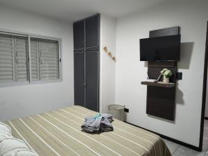 a bedroom with a bed and a television in it at DS confort dpto 3 in General Pico