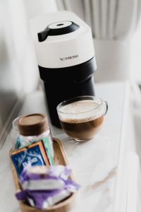 a coffee maker and a bowl of chocolate on a counter at The Yorkshire Unicorn in Skipton +64 photos