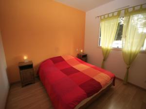 a bedroom with a bed and a window with two candles at Villa with Private Pool in Plestin-les-Grèves in Plestin-les-Grèves +20 photos