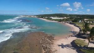 an aerial view of a beach with the ocean at Residencial Rosa da Barra in Canguaretama +7 photos