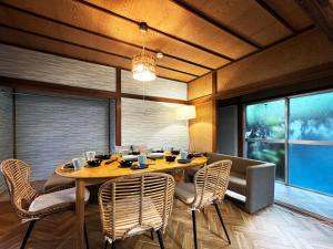 a dining room with a wooden table and chairs at #26 Yokosuka kamoi in Yokosuka