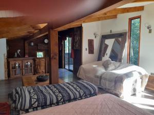 a bedroom with two beds in a room at collico lodge in Villarrica