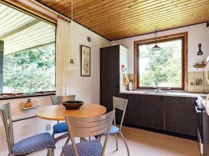a kitchen and dining room with a table and chairs at 6 person holiday home in Øster Assels in Øster Assels