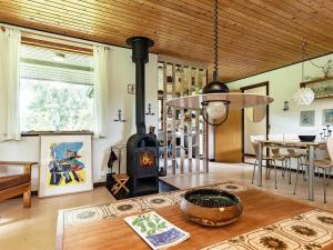 a living room with a wood burning stove in it at 6 person holiday home in Øster Assels in Øster Assels
