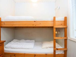 a bunk bed in a small room with a bunk bed in a house at 4 person holiday home in Ans By-By Traum in Roe
