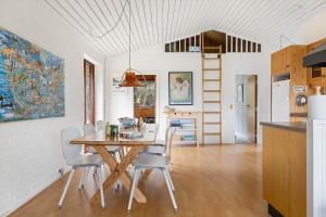 a kitchen and dining room with a table and chairs at TV1651-Bindslev-Vestervej-54 in Bindslev +19 photos