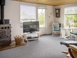 a living room with a flat screen tv and a stove at 6 person holiday home in Thisted in Thisted