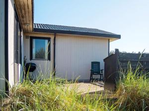 a house with a chair in front of it at 6 person holiday home in Thisted in Thisted